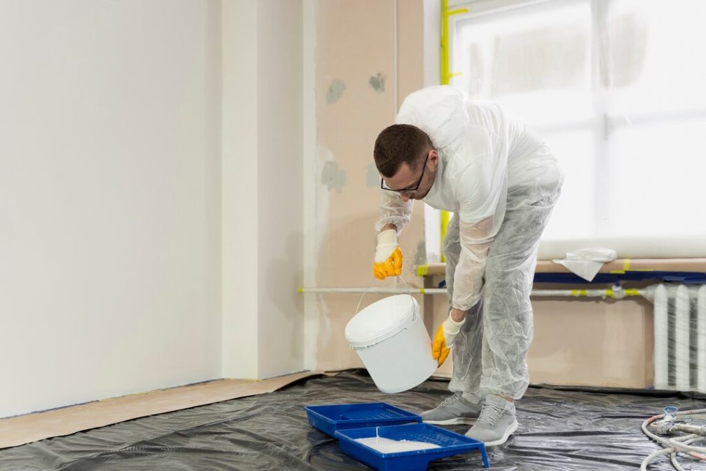 Basement Waterproofing: Common Problems & Permanent Solutions 3 full-shot-man-pouring-paint